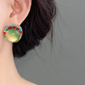Close-up of elegant French retro round resin earring with colorful beads worn by model