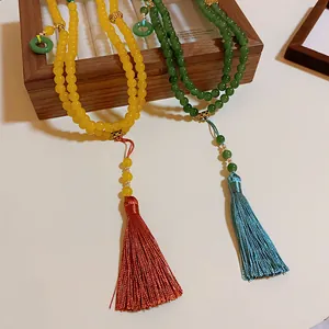 Nahaufnahme von New Chinese Style Perlenketten mit langen Seidenquasten in Gelb und Grün