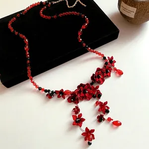 Elegant red glass beaded waist chain with floral tassel detail