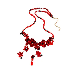 Elegant red flower beaded waist chain with black accents and gold extension chain.