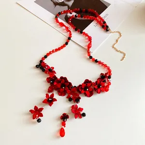 Close-up of red and black glass beaded flower waist chain with delicate tassels