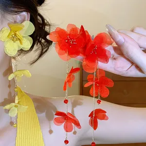 Detailed view showing the delicate chiffon flower petals and long tassels of these earrings