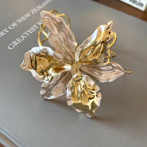 Detailed view of elegant vintage lily flower cuff bracelet with gold and pearl finish
