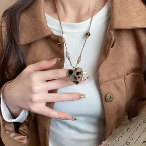 Maillard style heart-shaped leopard print pendant necklace on a brown cord with beads