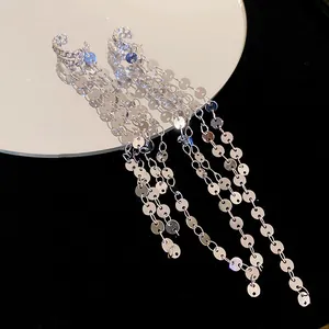 Close-up of silver three-layer geometric tassel clip-on earrings with metallic luster.