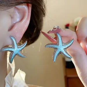 Summer vacation style teal enamel starfish stud earrings with silver textured border