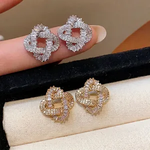 Elegant 18k gold plated intertwined stud earrings with shimmering zircon stones for women