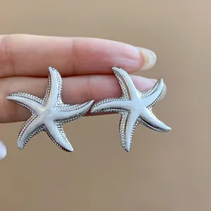 Detailed view of silver starfish earrings with smooth drip oil finish for beach vacations.