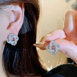 Elegant 18k gold plated silver needle stud earrings with a twisted zircon design
