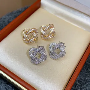 Luxury intertwined zircon heart earrings in gold and silver plating presented in box.
