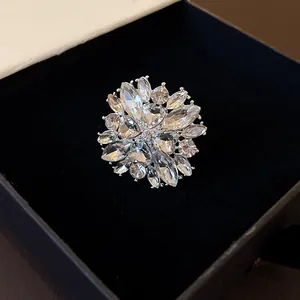 Detailed macro view of a sparkling crystal flower ring inside a black velvet gift box