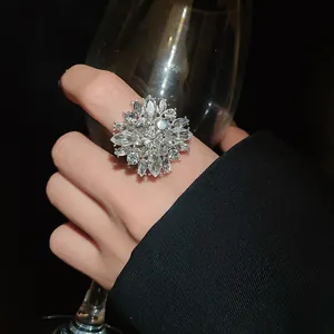 Close-up of sparkling crystal flower ring with elegant silver finish worn on index finger