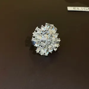 Macro detail of a sparkling silver flower ring set with brilliant clear crystals