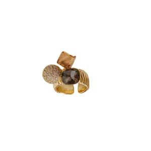 Elegant gold-plated open ring featuring a sparkling zirconia sphere and amber stones.