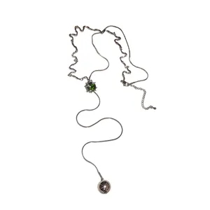 Minimalist adjustable tassel necklace featuring a green zircon and silver sphere pendant.