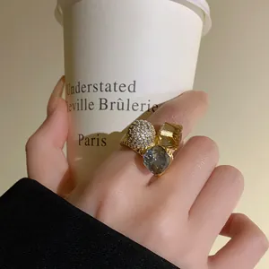 Close-up of gold-plated open ring featuring zircon pave and faceted crystal stones
