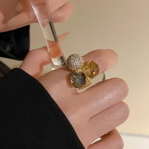 Close-up of luxury gold plated open ring with zircon sphere and crystals