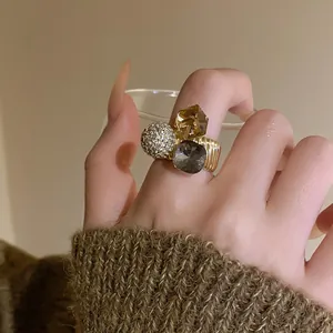 Detail shot of gold-plated open ring with pavé zirconia and colorful crystals.