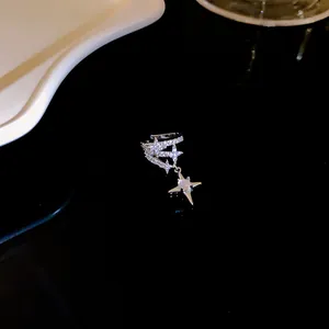 Close-up of a silver-toned star ear cuff adorned with sparkling cubic zirconia stones