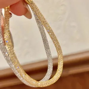 Elegant close-up detail of a French mesh zircon bracelet in gold and silver finish