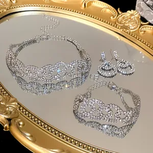 Detailed view of luxury silver rhinestone jewelry set on a vintage golden mirror
