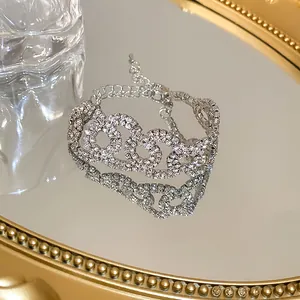 Close-up of sparkling rhinestone link accessory reflected on a golden mirror
