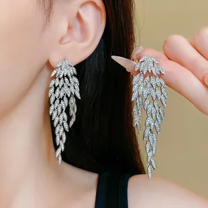 Macro view of elegant silver leaf tassel earrings with sparkling cubic zirconia detail