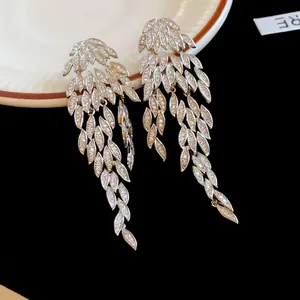 Detailed close-up view of elegant silver-toned leaf tassel earrings with sparkling zircon stones