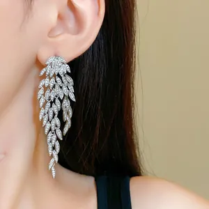 Close-up of elegant silver zircon leaf tassel earrings showing intricate leaf patterns.