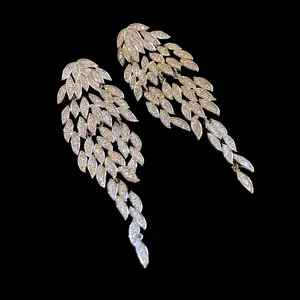 Detail view of elegant silver leaf tassel earrings with pavé-set sparkling zircons