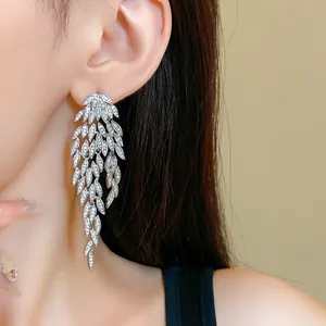 Side view detail of elegant silver leaf tassel earrings with sparkling pave zircon stones