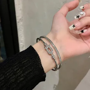 Close-up detail of elegant silver zircon titanium steel bracelet set on a model's wrist