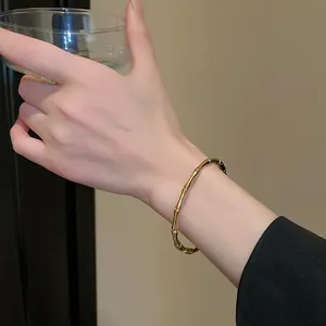 Elegant close-up view of a gold-plated stainless steel bamboo style bracelet on a wrist