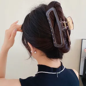 Vue détaillée d'une pince à cheveux minimaliste en acrylique ambre sur cheveux