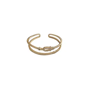 Elegant double-layered gold plated stainless steel bangle with zircon horse-bit design
