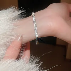 Close-up of elegant silver-toned bamboo joint bangle with paved sparkling cubic zirconia stones