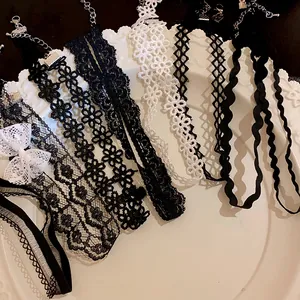 Close-up view of various elegant lace and mesh choker necklaces in black and white styles