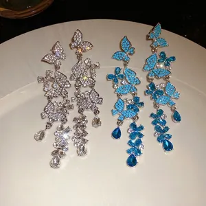 Sparkling butterfly tassel earrings with silver needles and blue zirconia stones.