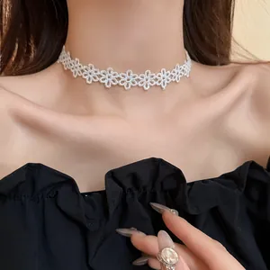 Detailed close-up of a white floral lace choker necklace worn by an elegant model