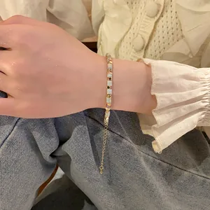 A close-up detail view of a stylish colorful cylinder bead bracelet on a female wrist