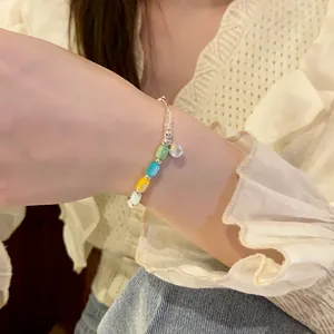 Close-up of a stylish colorful cylindrical bead elastic bracelet on a woman's wrist