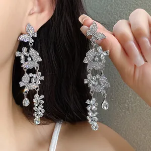 Detailed close-up of sparkling silver butterfly tassel earrings with rhinestones