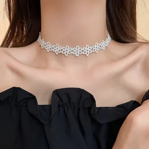 Close-up of elegant white floral lace choker necklace worn on model's neck area