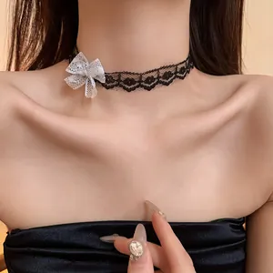 Close-up of black lace choker with delicate white mesh bow for a gothic elegant look