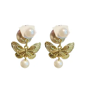 Elegant gold butterfly stud earrings with drop pearls and silver needle backs