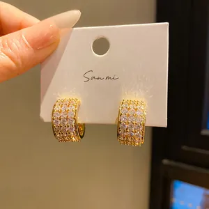 Macro view of luxury gold-plated hoop earrings with pave-set cubic zirconia crystals