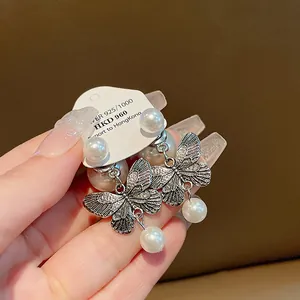 Vintage silver butterfly pearl earrings with delicate wing details and elegant luster