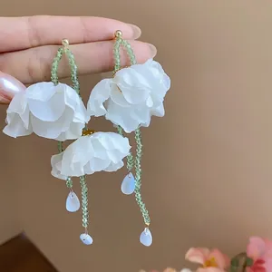 Elegant handmade white fabric flower tassel earrings with green beaded chains and drops
