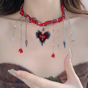 Close-up of gothic red stone beaded choker necklace with heart and cross charms on model