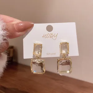 Close-up of elegant clear square crystal drop earrings with 925 silver posts